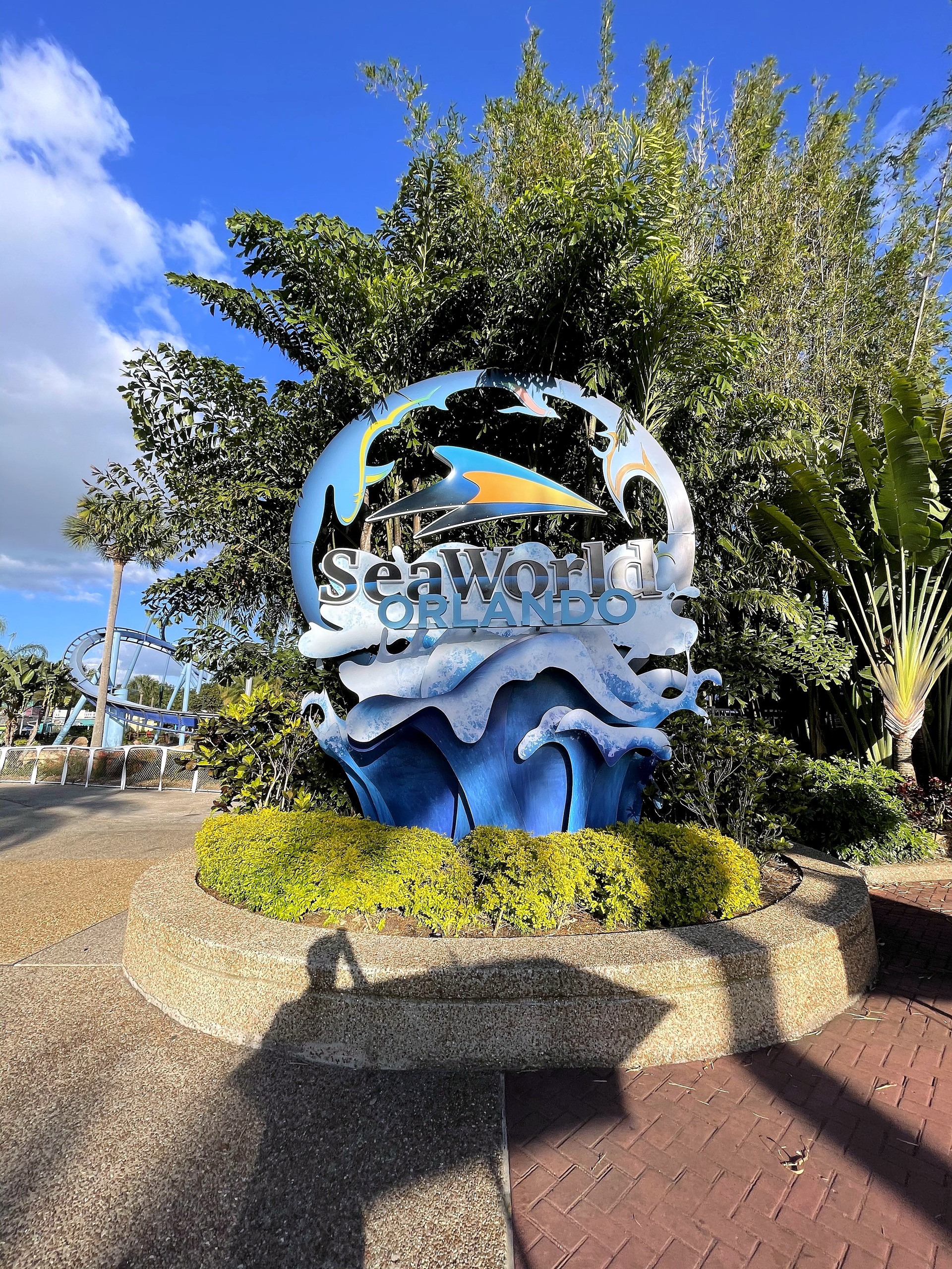 The SeaWorld Orlando sign on its planter along the entrance walk at SeaWorld Orlando, March 2021