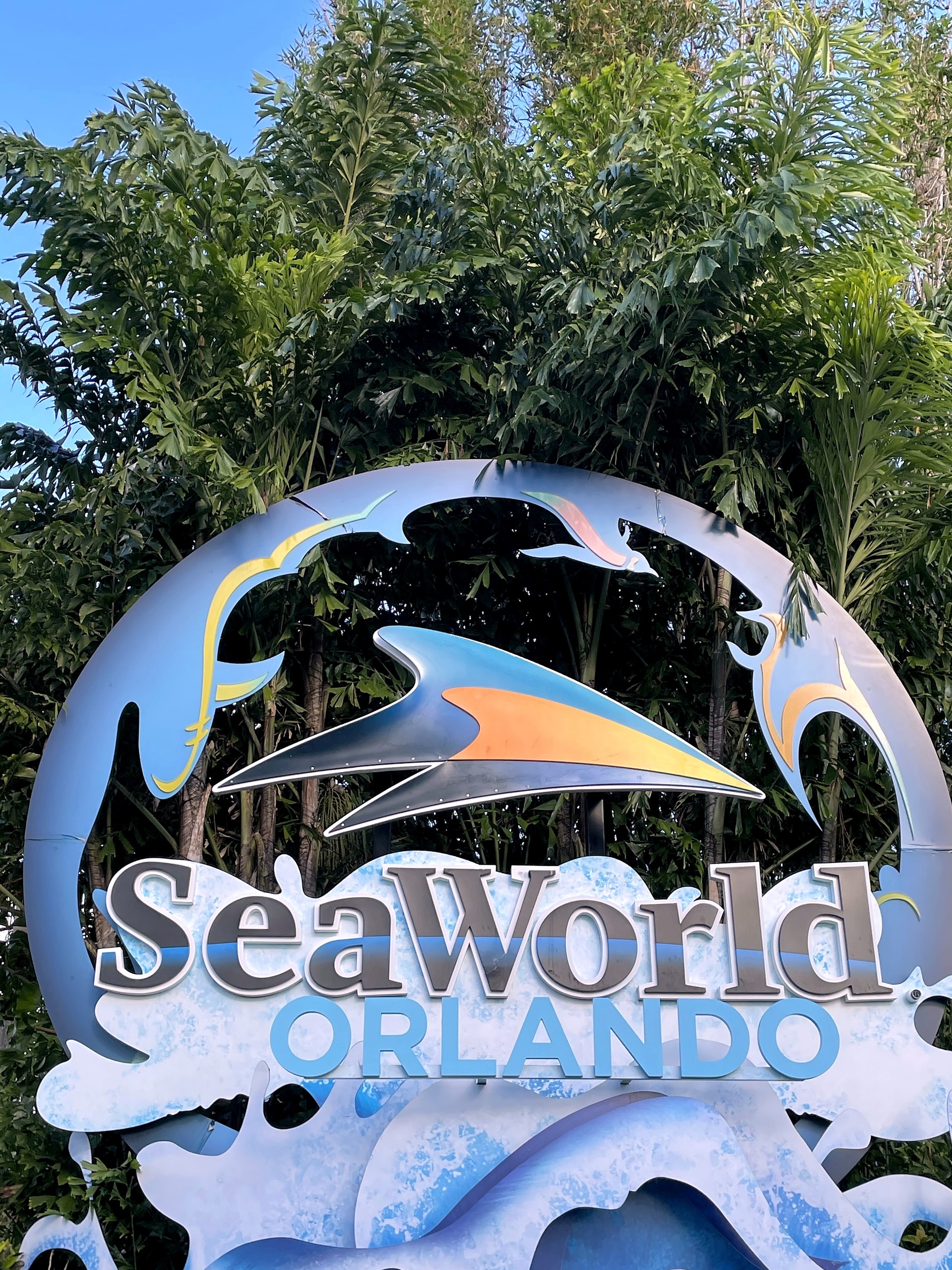 The SeaWorld Orlando sign among the trees at SeaWorld Orlando, March 2021