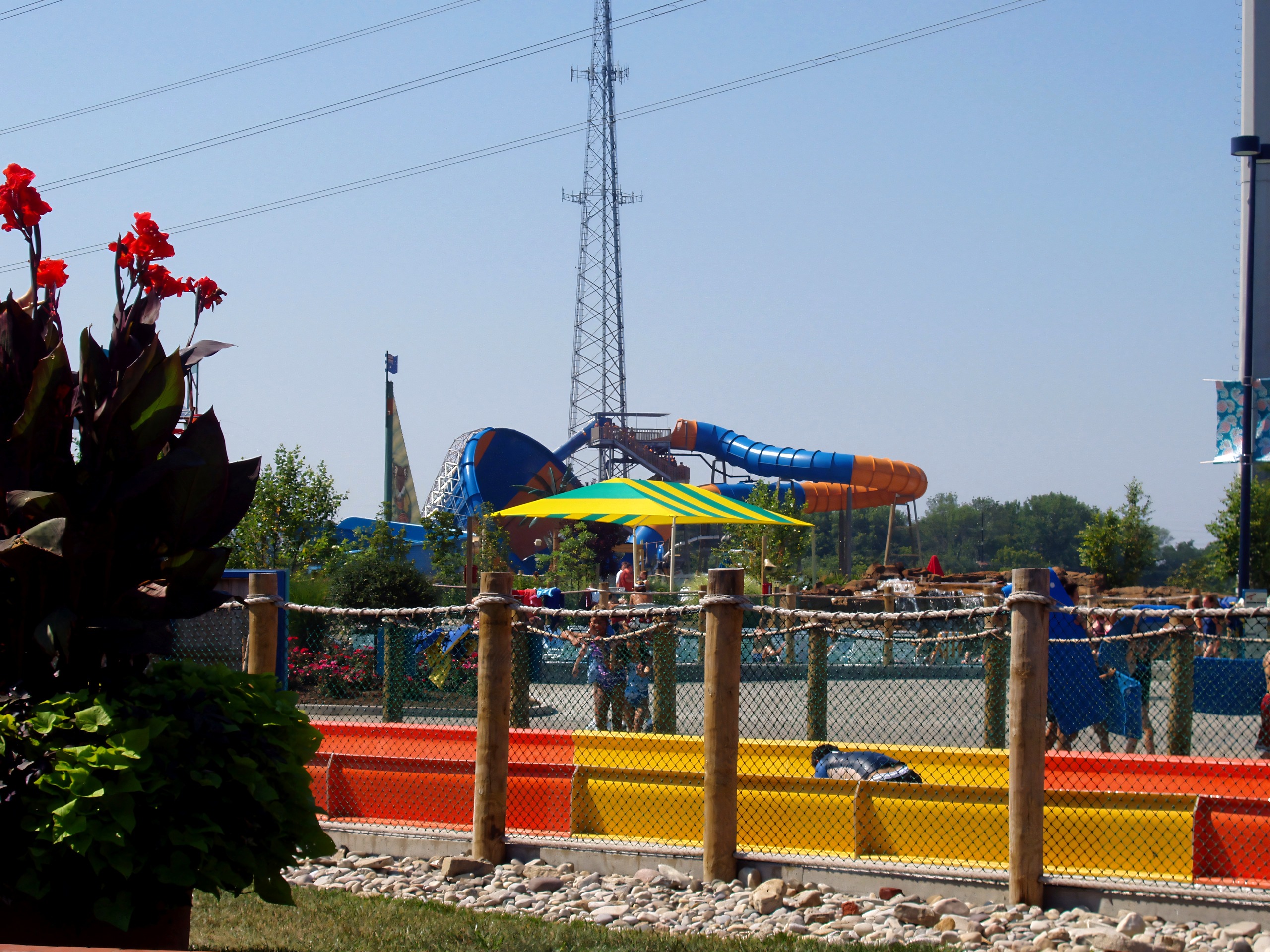Tube slides running down to the pool behind a rope fence and flower beds at Kings Island's water park, then Boomerang Bay and now Soak City, July 2005