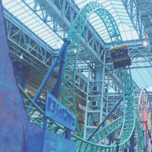 A Rock Bottom Plunge train on the teal track above the ride sign and the Ferris wheel, Nickelodeon Universe, November 2015