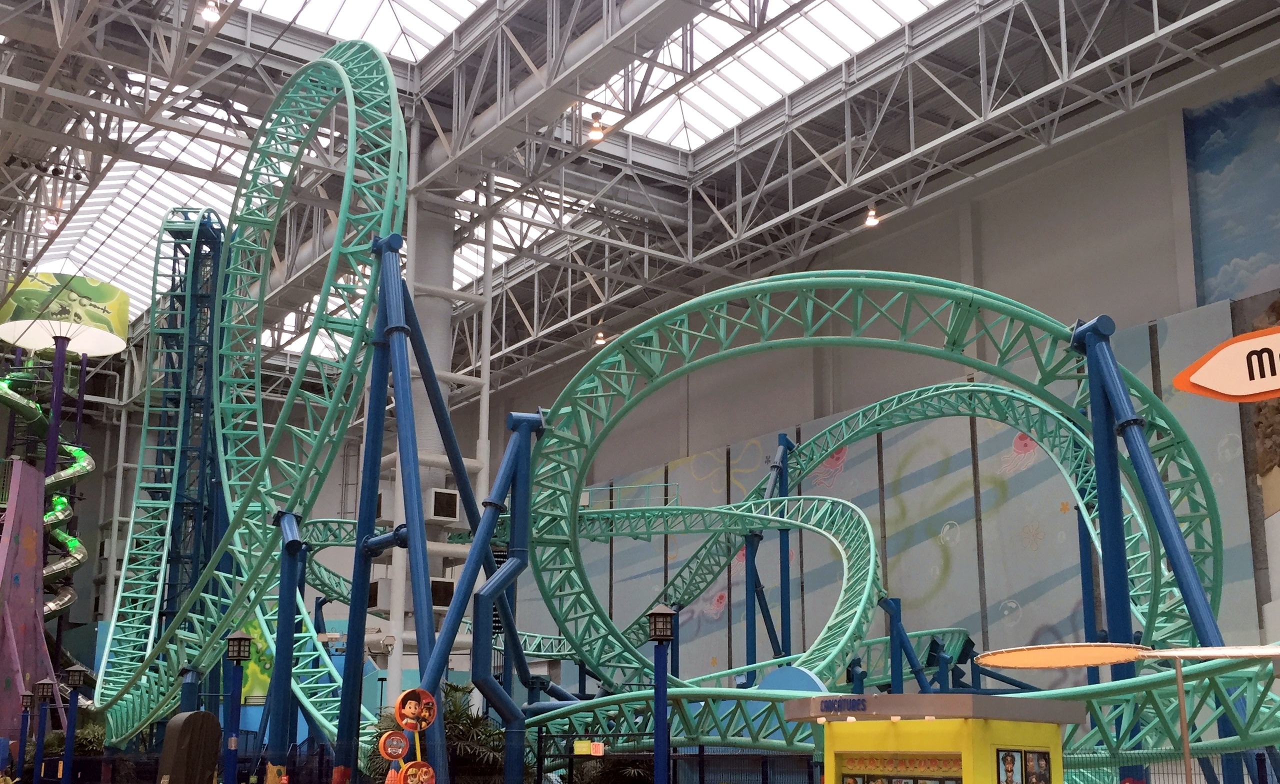 The SpongeBob SquarePants Rock Bottom Plunge layout: the vertical lift, the drop and the teal loops under the skylights at Nickelodeon Universe, November 2015