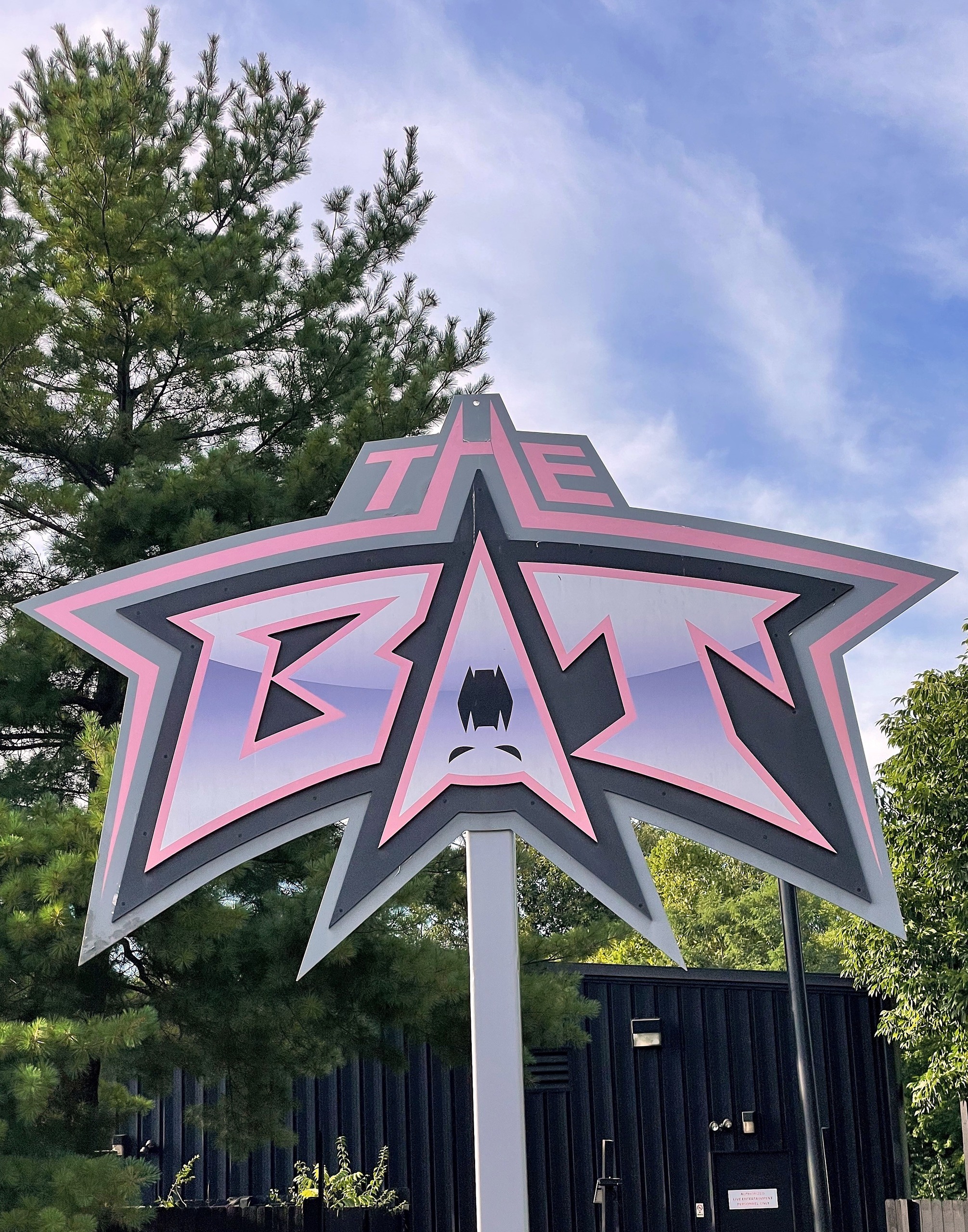 The Bat's star-shaped entrance sign against the sky, Kings Island, July 2022