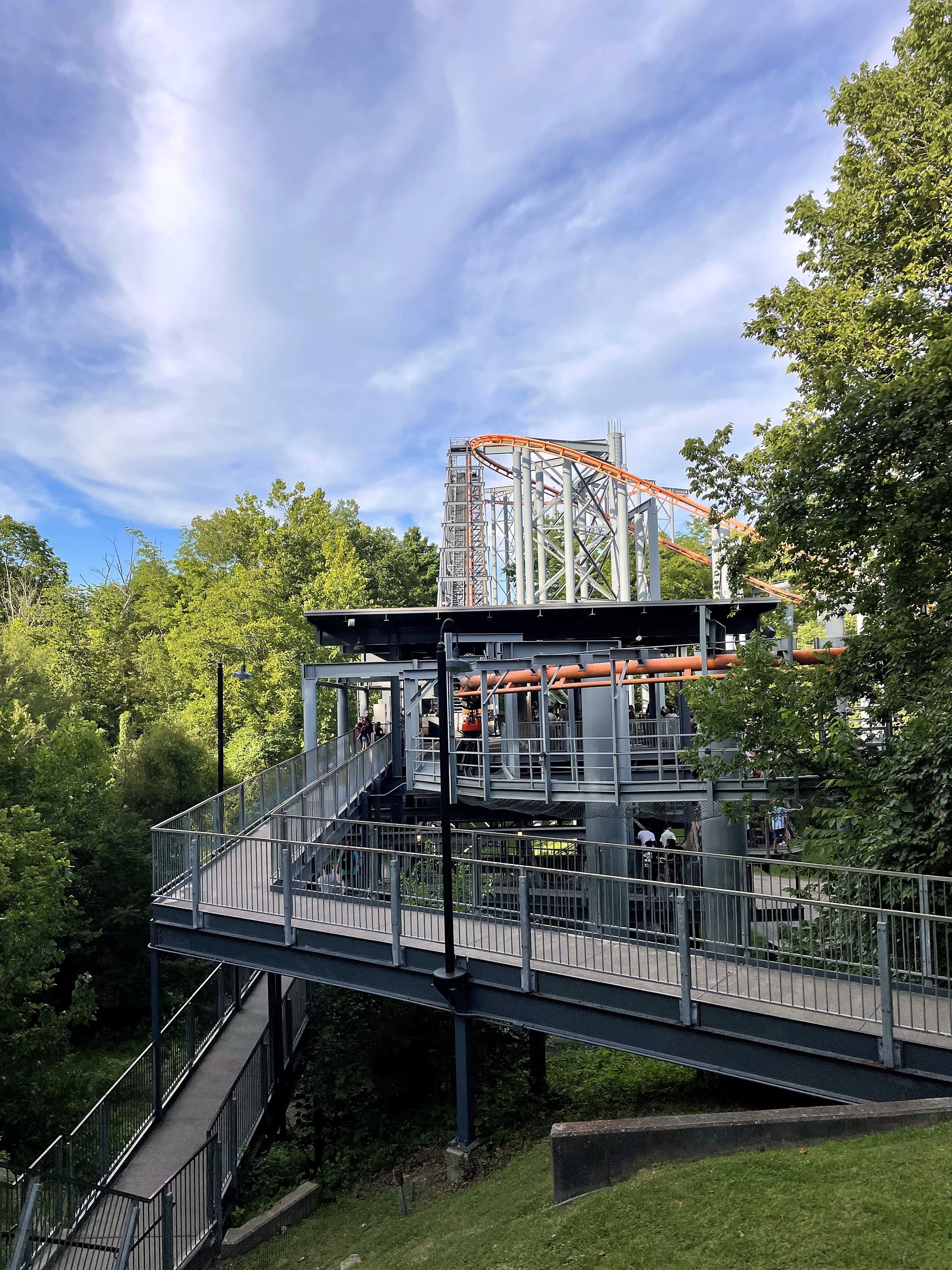 The Bat's station walkway in the trees with the lift structure behind, Kings Island, July 2022