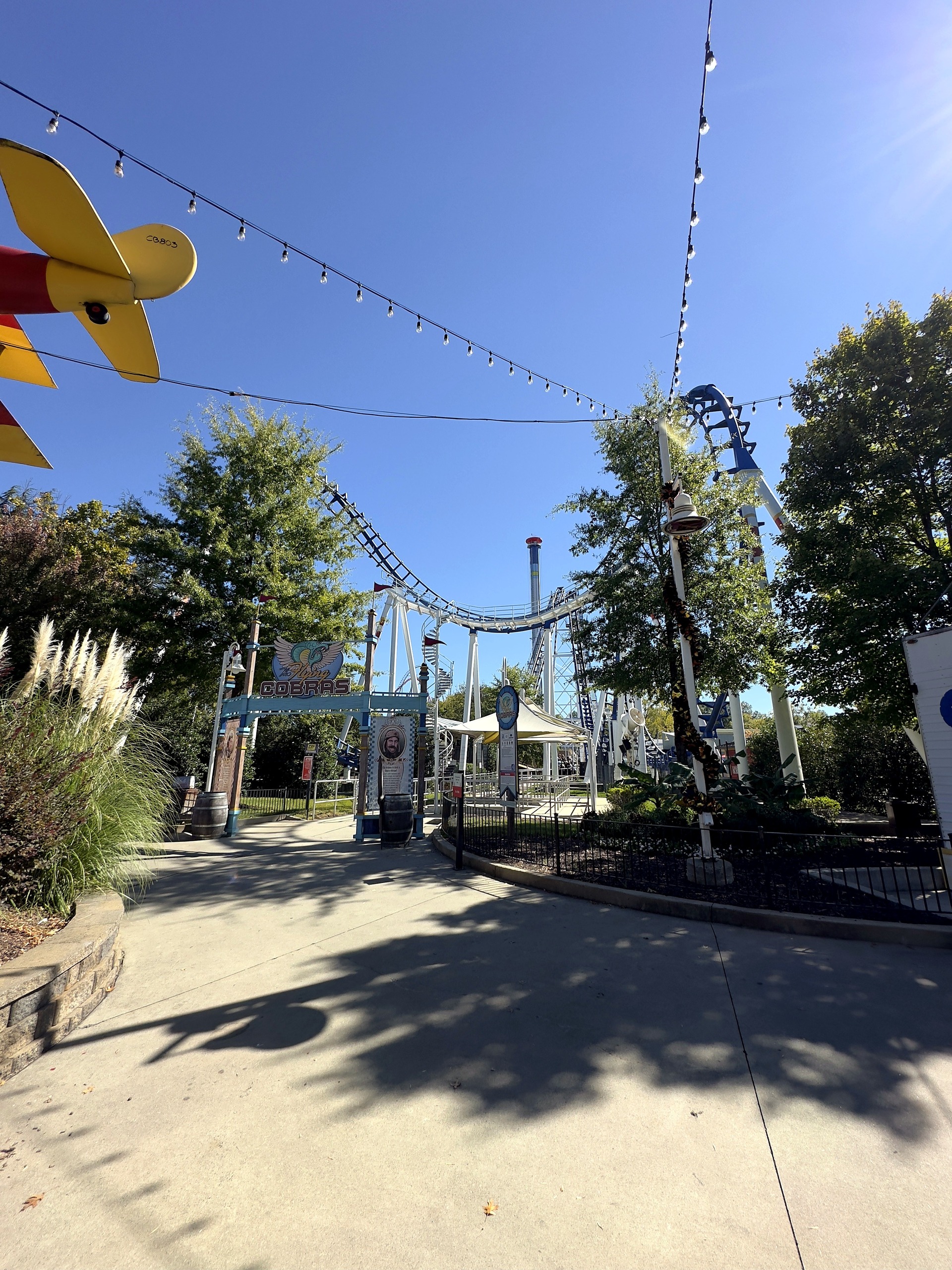 The Flying Cobras entrance and track down the midway at Carowinds, October 2024