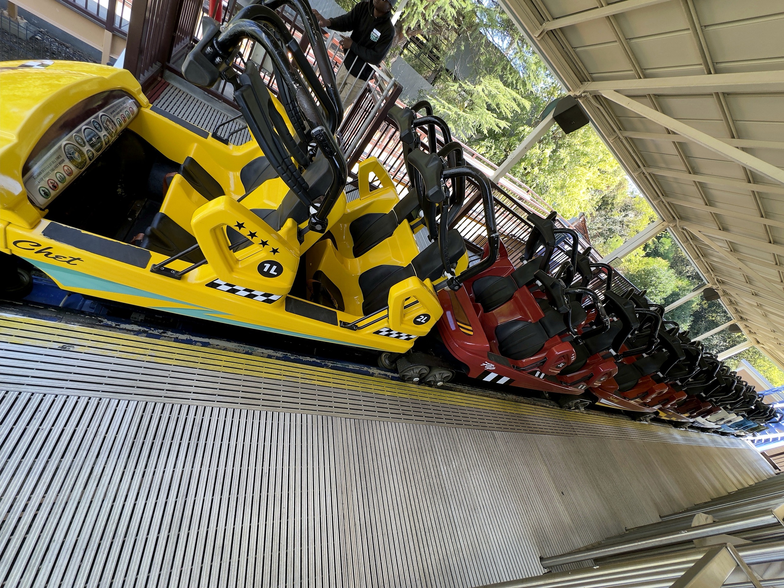 A Flying Cobras train of yellow and red cars waiting in the station at Carowinds, October 2024