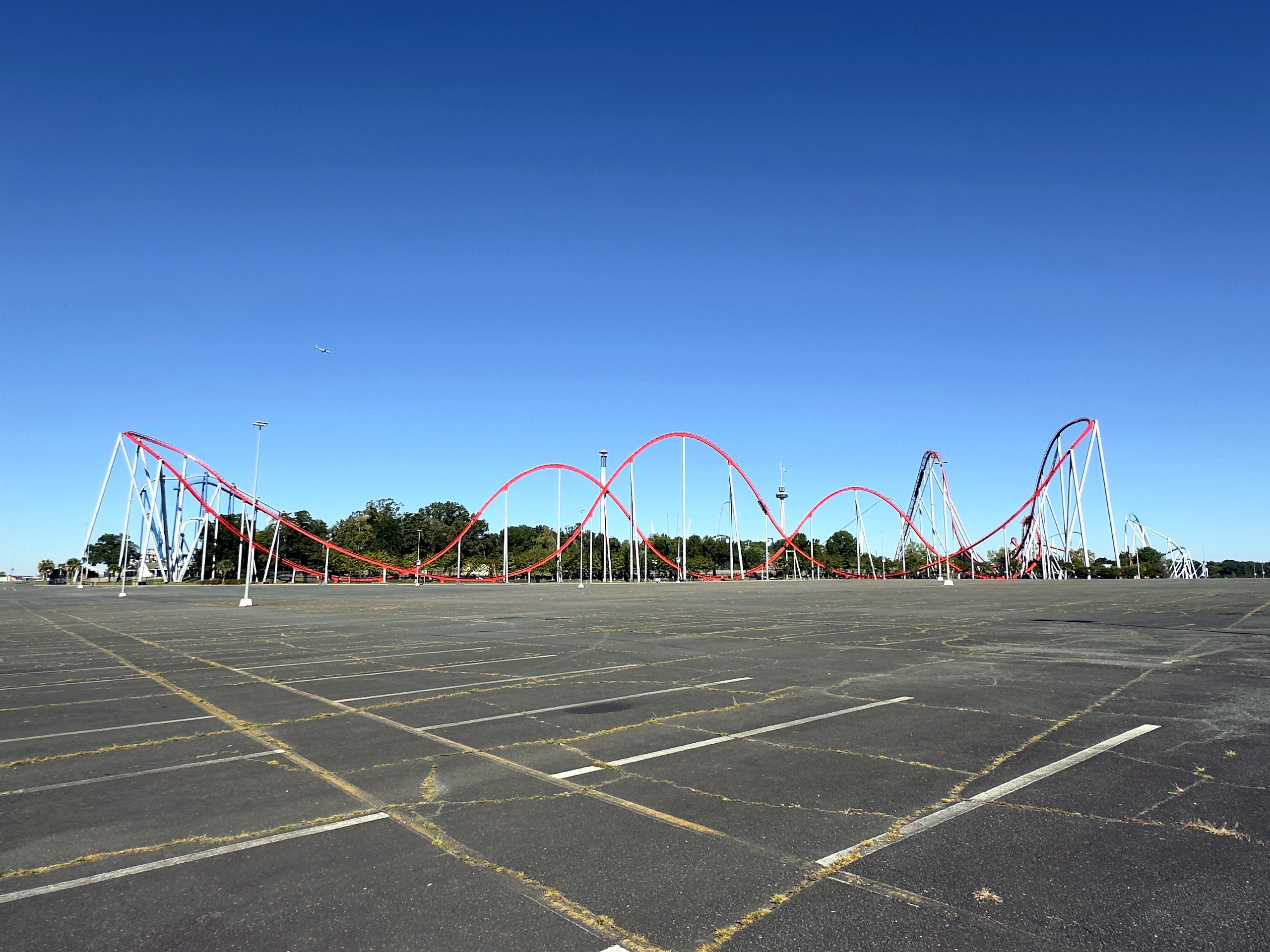 Thunder Striker's red hills stretching across the parking lot at Carowinds, October 2024