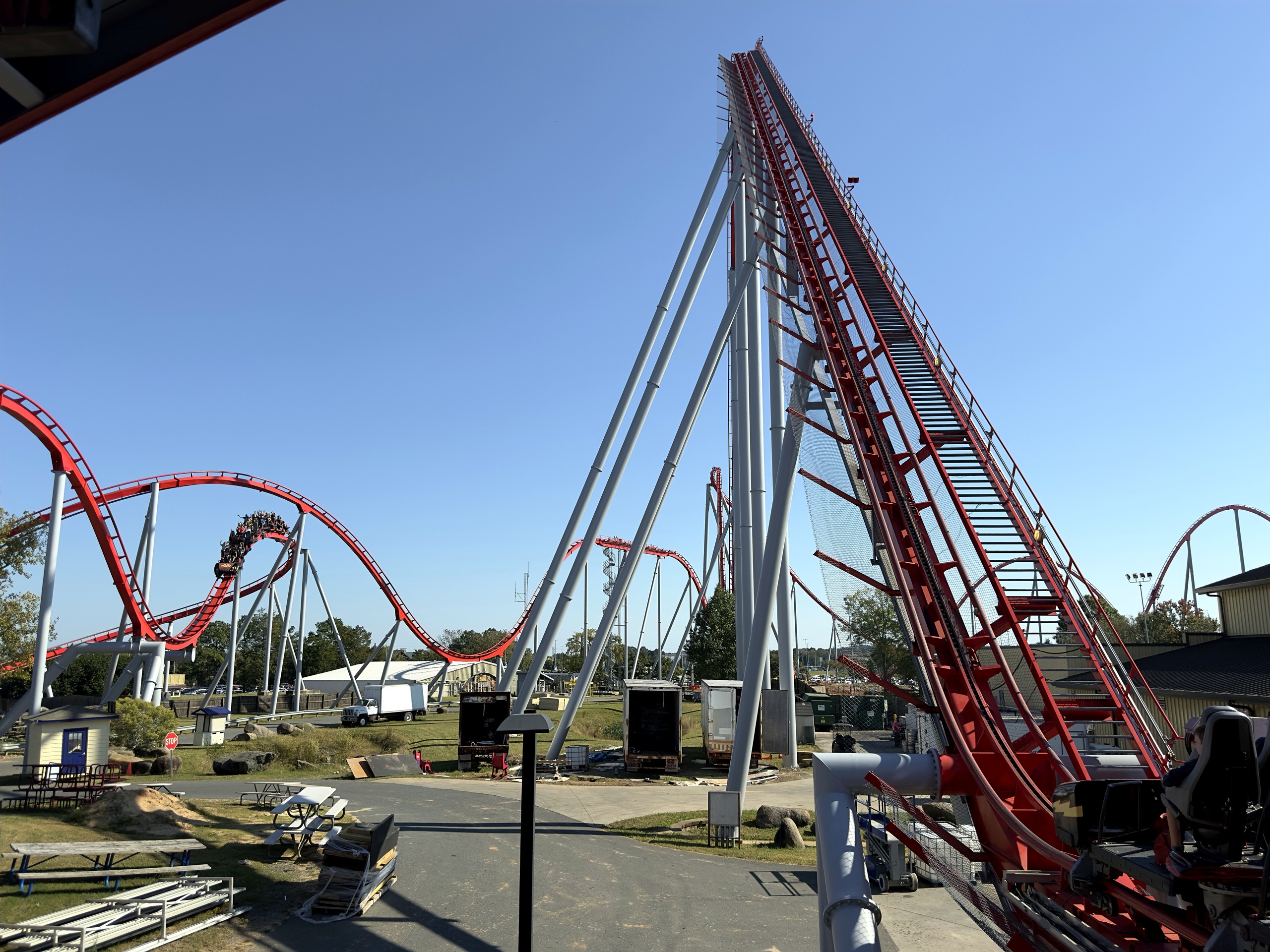 Thunder Striker's lift hill rising from the station with a train on the hills at Carowinds, October 2024