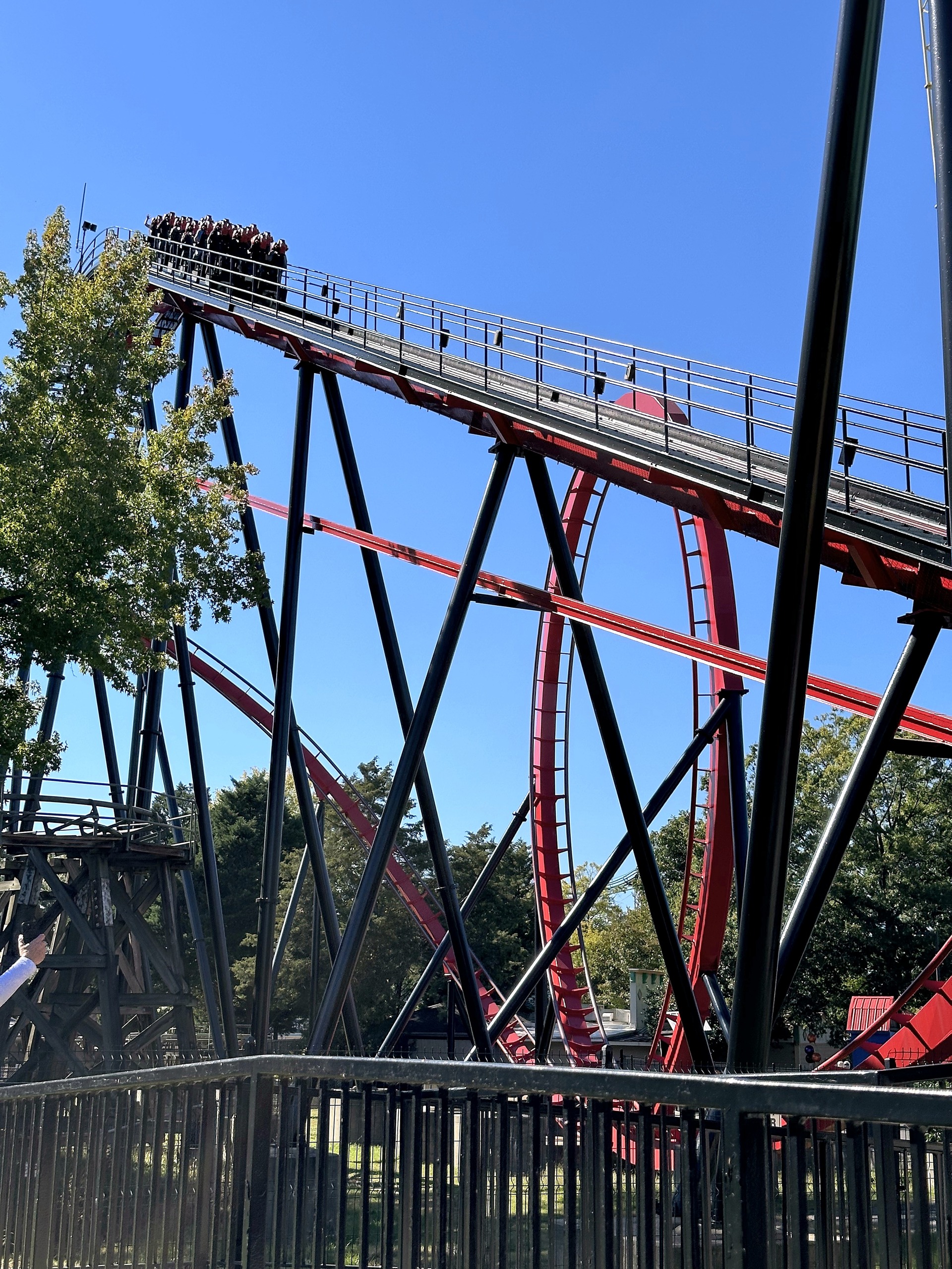 A Vortex train at the top of the lift hill above the red vertical loop at Carowinds, October 2024