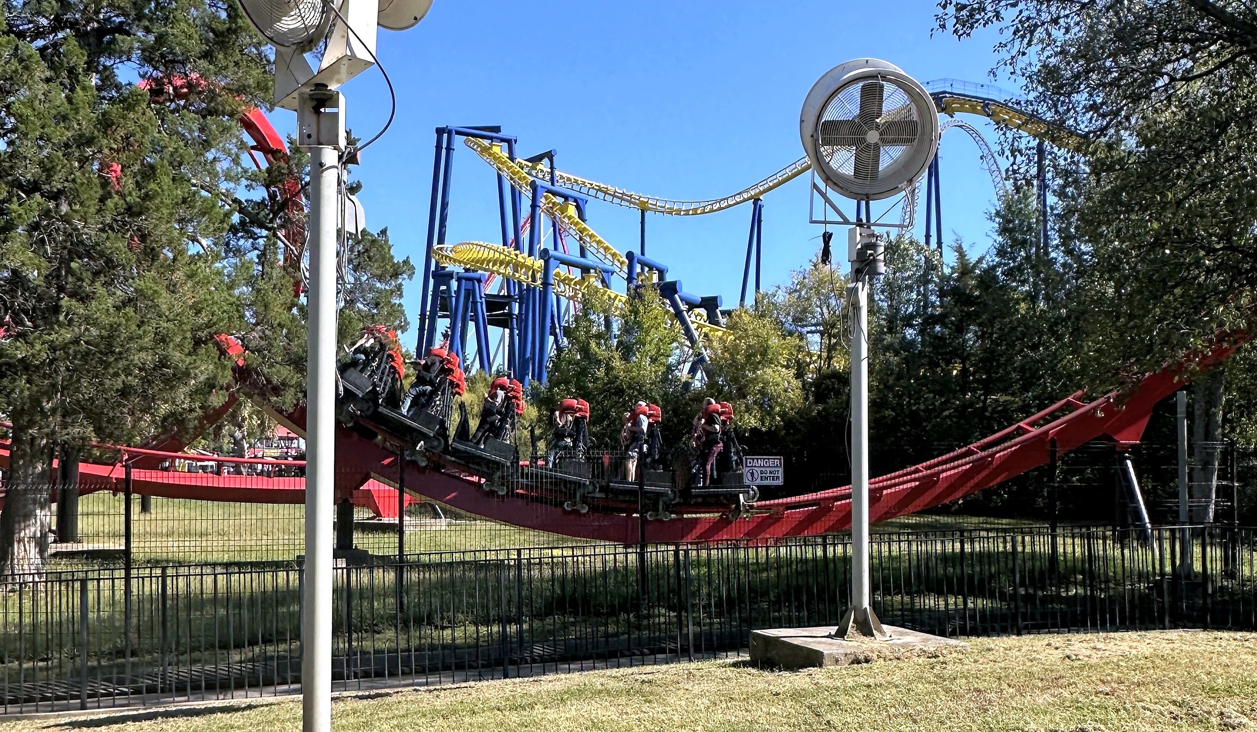 A Vortex train on the low red track with Nighthawk's yellow track behind at Carowinds, October 2024