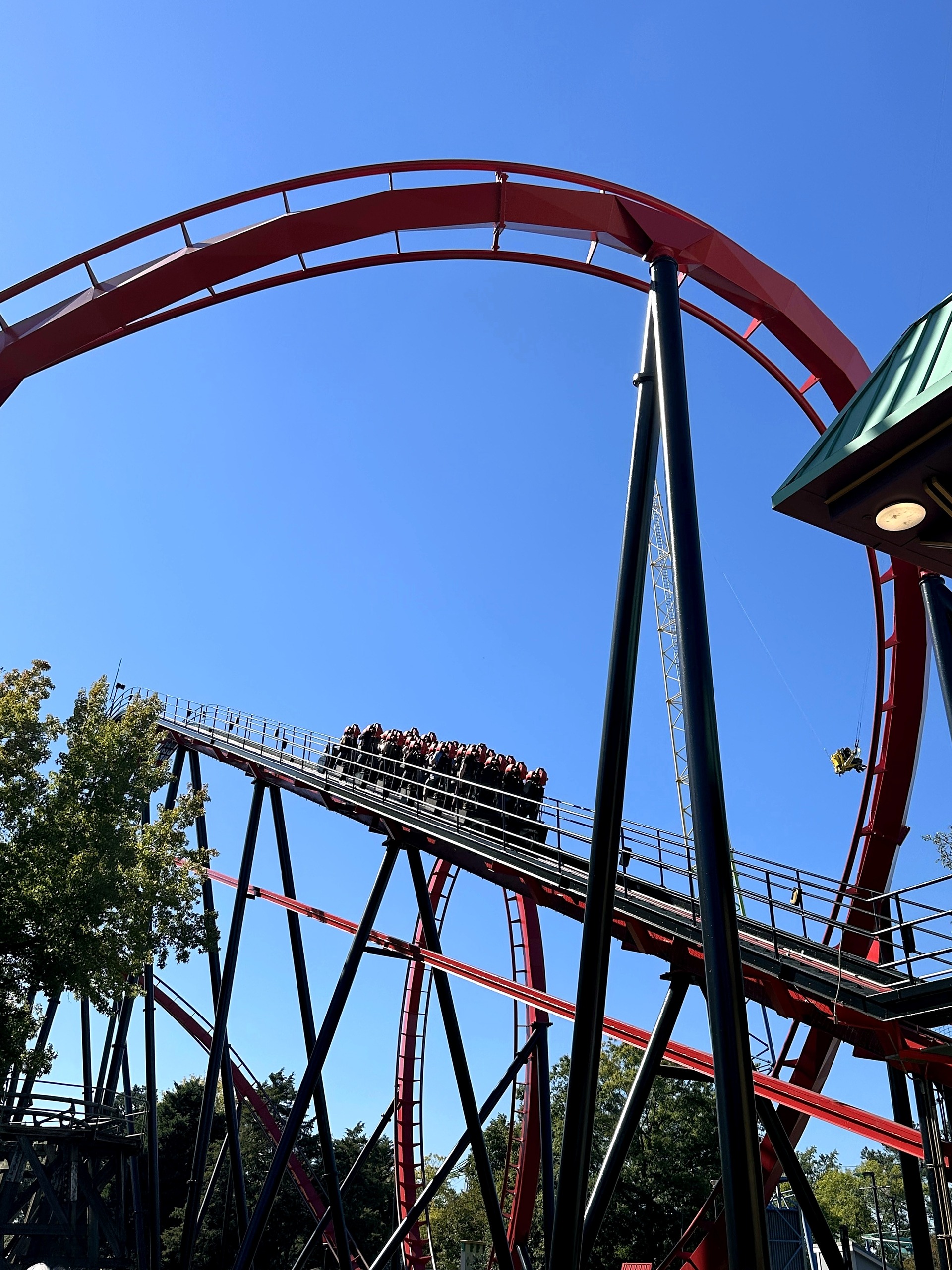 A Vortex train high on the lift hill below the vertical loop at Carowinds, October 2024