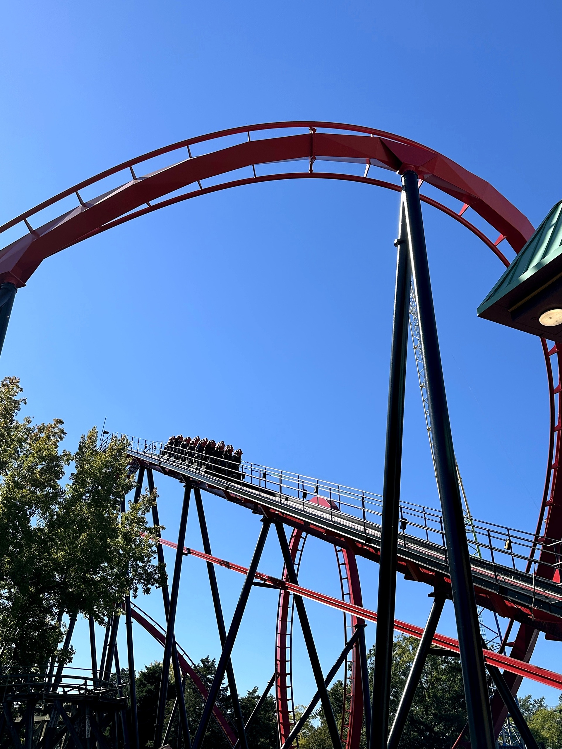 A Vortex train near the top of the lift hill under the vertical loop at Carowinds, October 2024