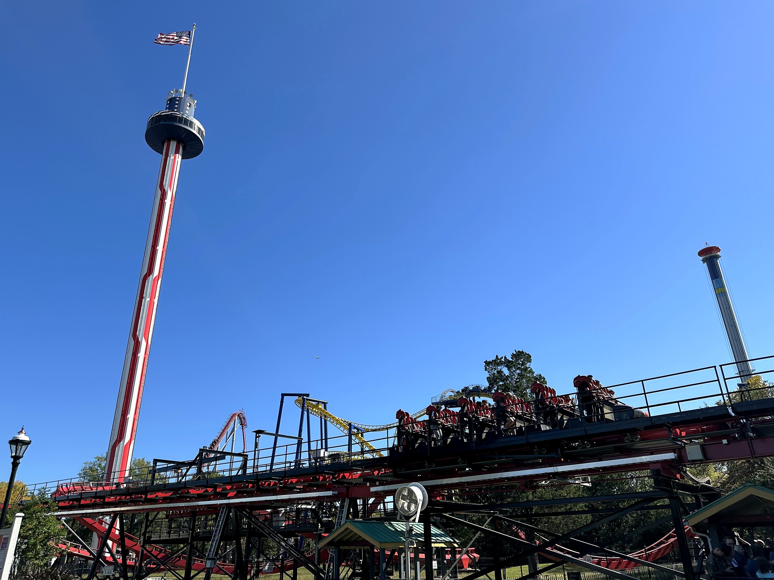 A Vortex train on the elevated track with the observation tower behind at Carowinds, October 2024